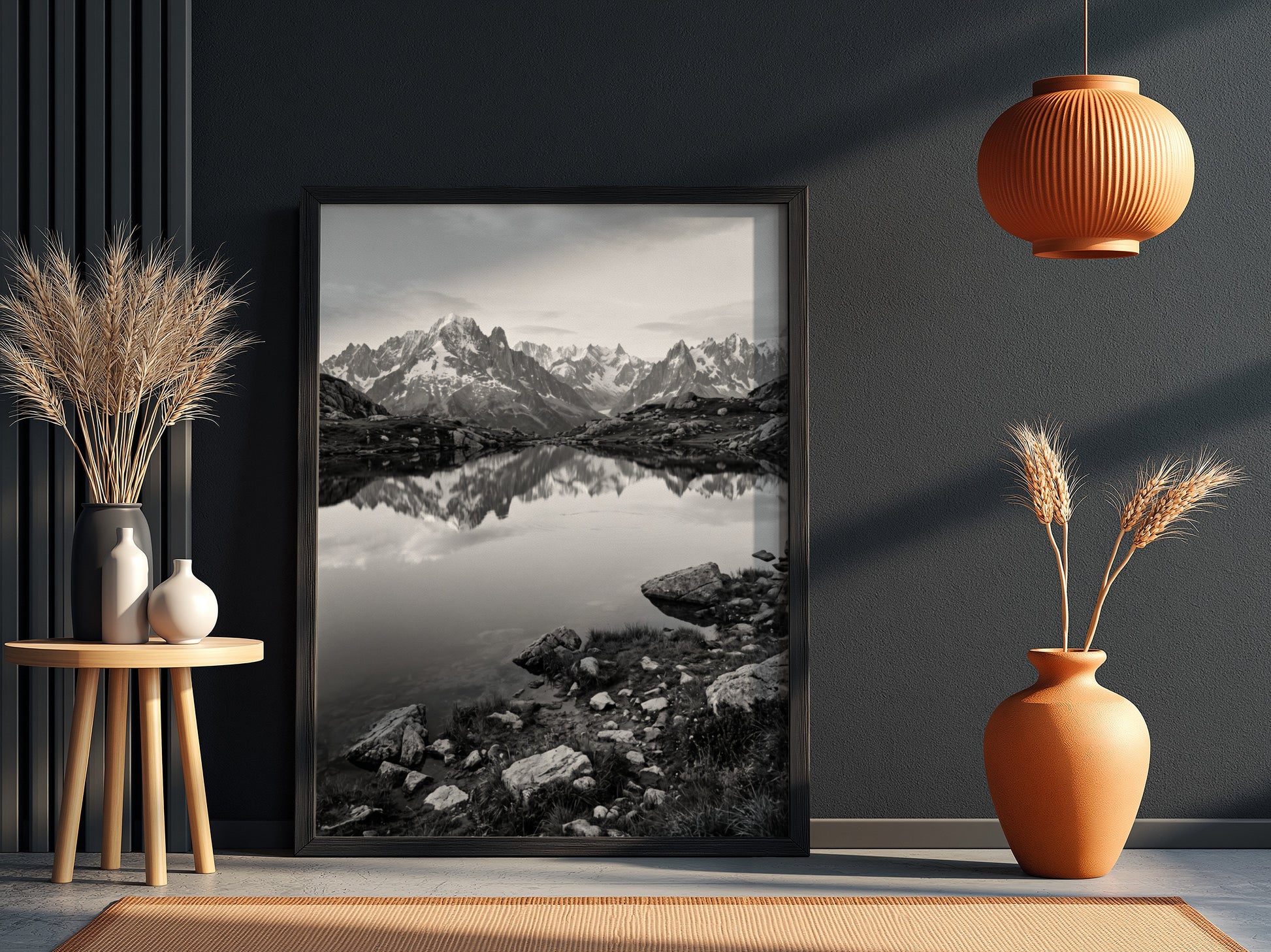 Black and white photographic wall decor showing alpine lake reflecting jagged mountain peaks and rocky shore