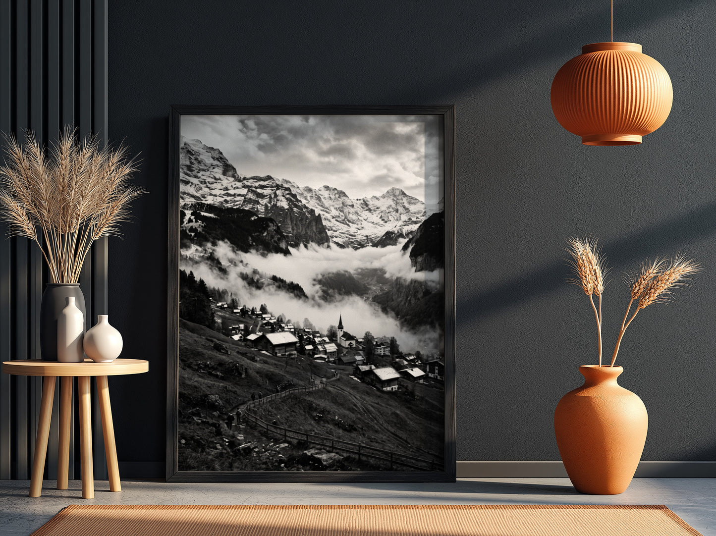 Black and white wall decor showing alpine village with snow-covered mountains and misty valley