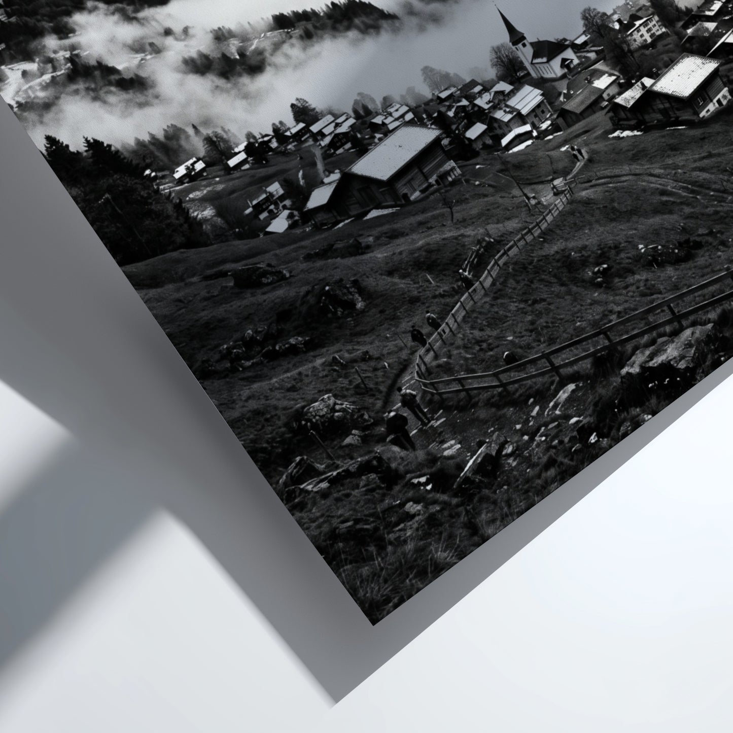 Black and white wall decor showing alpine village with snow-covered mountains and misty valley