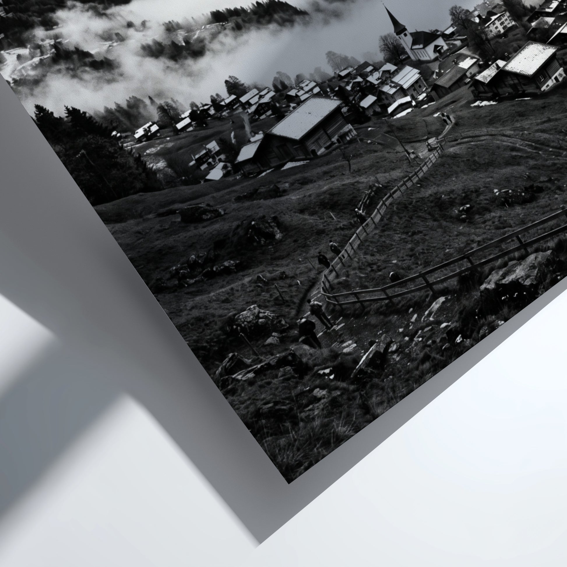 Black and white wall decor showing alpine village with snow-covered mountains and misty valley