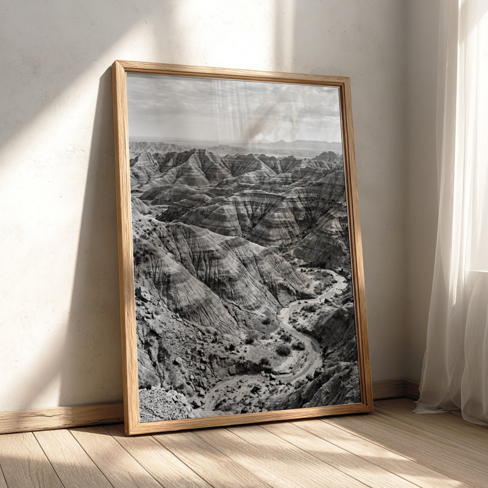 Badlands landscape poster in black and white showing eroded rocky terrain with layered geological formations