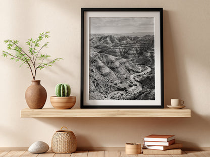 Badlands landscape poster in black and white showing eroded rocky terrain with layered geological formations