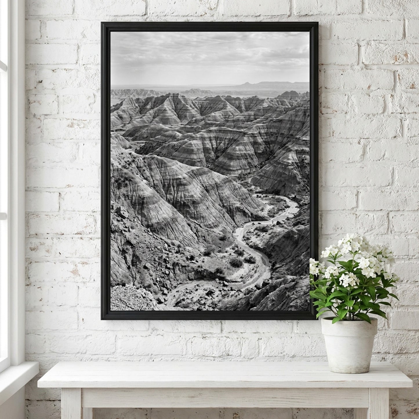 Badlands landscape poster in black and white showing eroded rocky terrain with layered geological formations