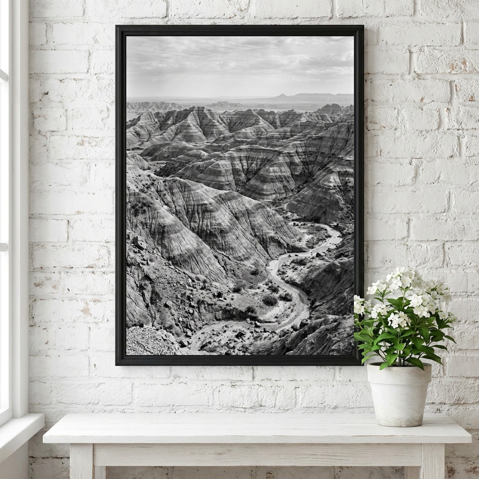 Badlands landscape poster in black and white showing eroded rocky terrain with layered geological formations