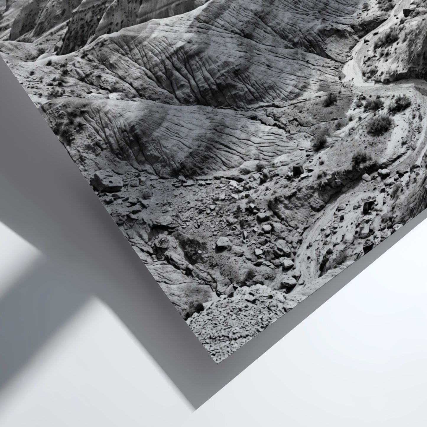 Badlands landscape poster in black and white showing eroded rocky terrain with layered geological formations