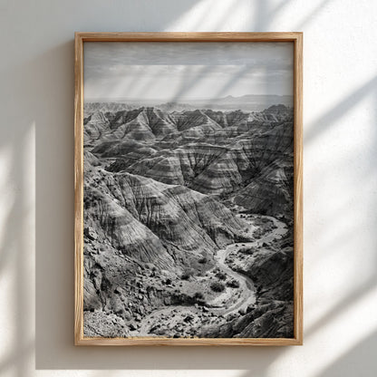 Badlands landscape poster in black and white showing eroded rocky terrain with layered geological formations