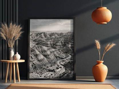 Badlands landscape poster in black and white showing eroded rocky terrain with layered geological formations
