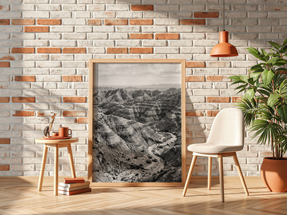 Badlands landscape poster in black and white showing eroded rocky terrain with layered geological formations