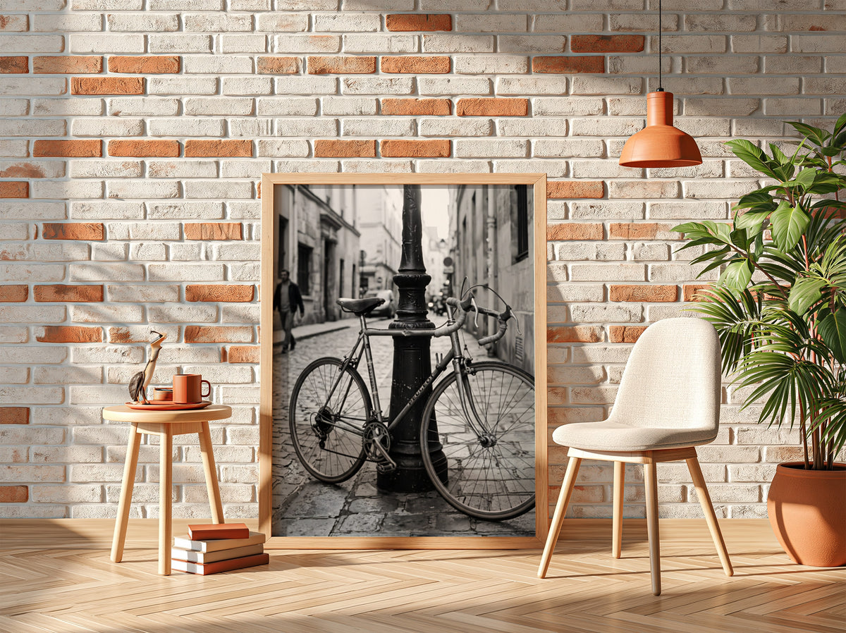 Black and white wall decor featuring vintage bicycle parked against ornate lamppost on cobblestone street