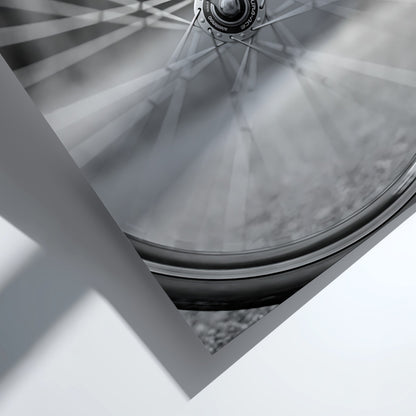 Black and white wall art of bicycle wheel in motion with blurred spokes and sharp mechanical details