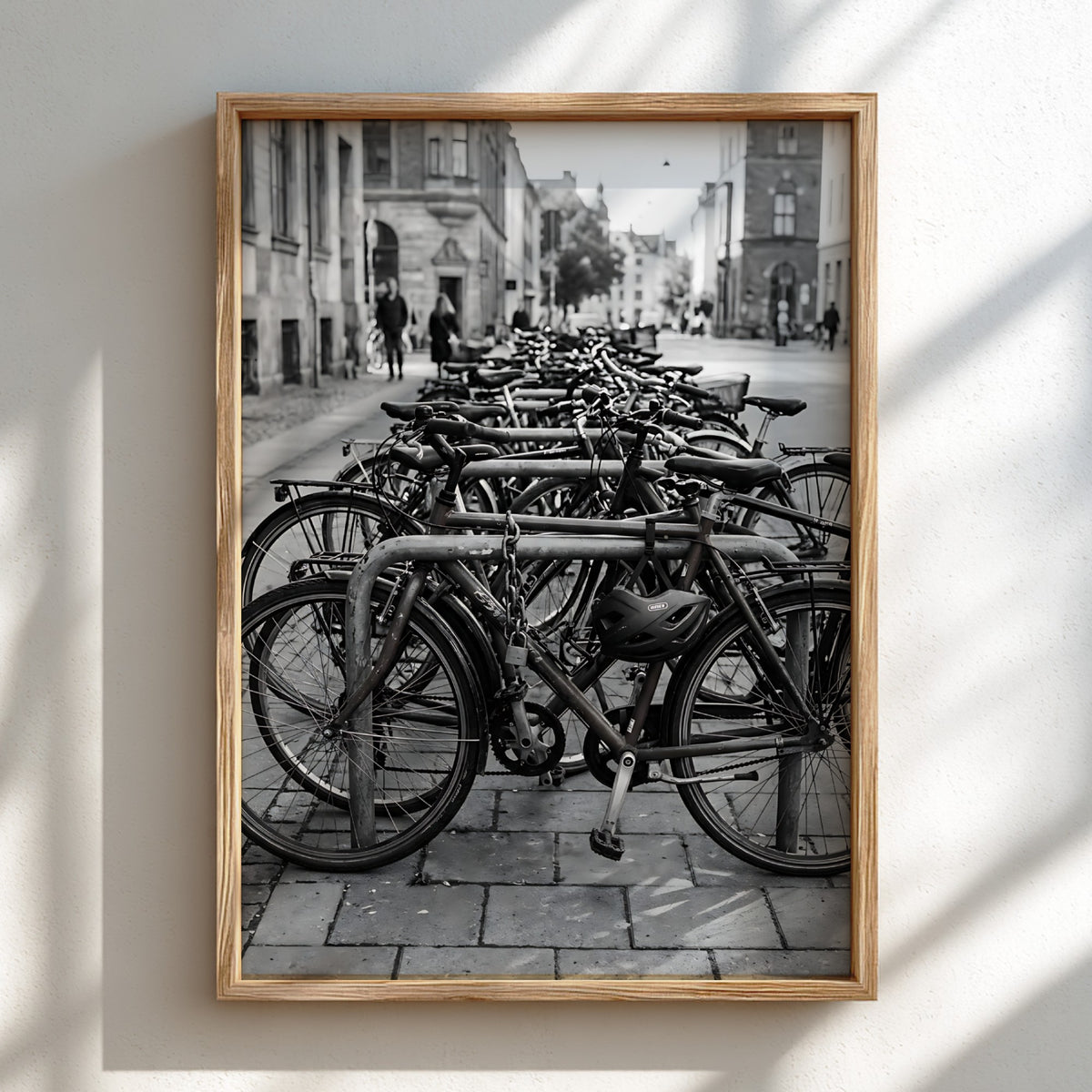 black and white wall decor showing bicycles parked at bike rack on cobblestone street with urban background