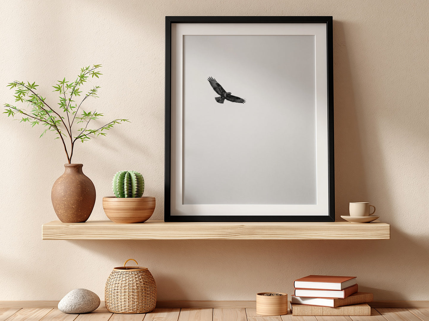Framed wall decor featuring a black bird in flight against a pale sky with natural wood frame