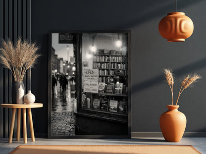 Black and white photographic wall decor showing a rainy evening bookshop window with books and reflections
