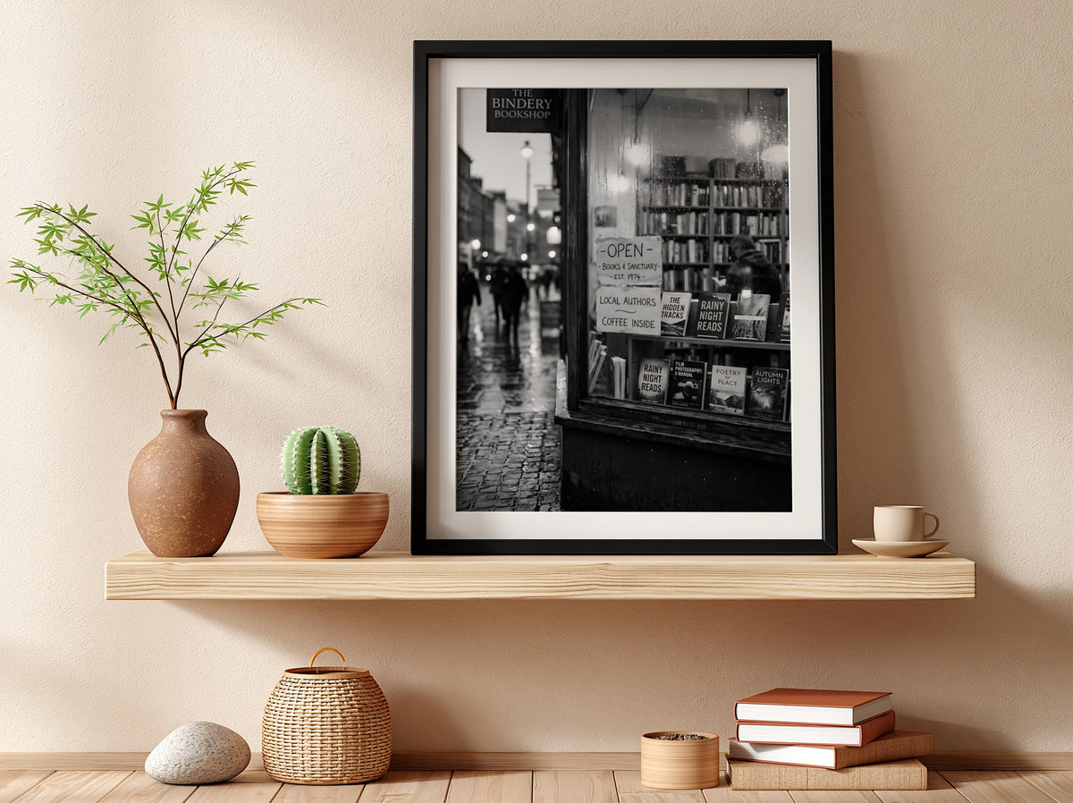 Black and white photographic wall decor showing a rainy evening bookshop window with books and reflections