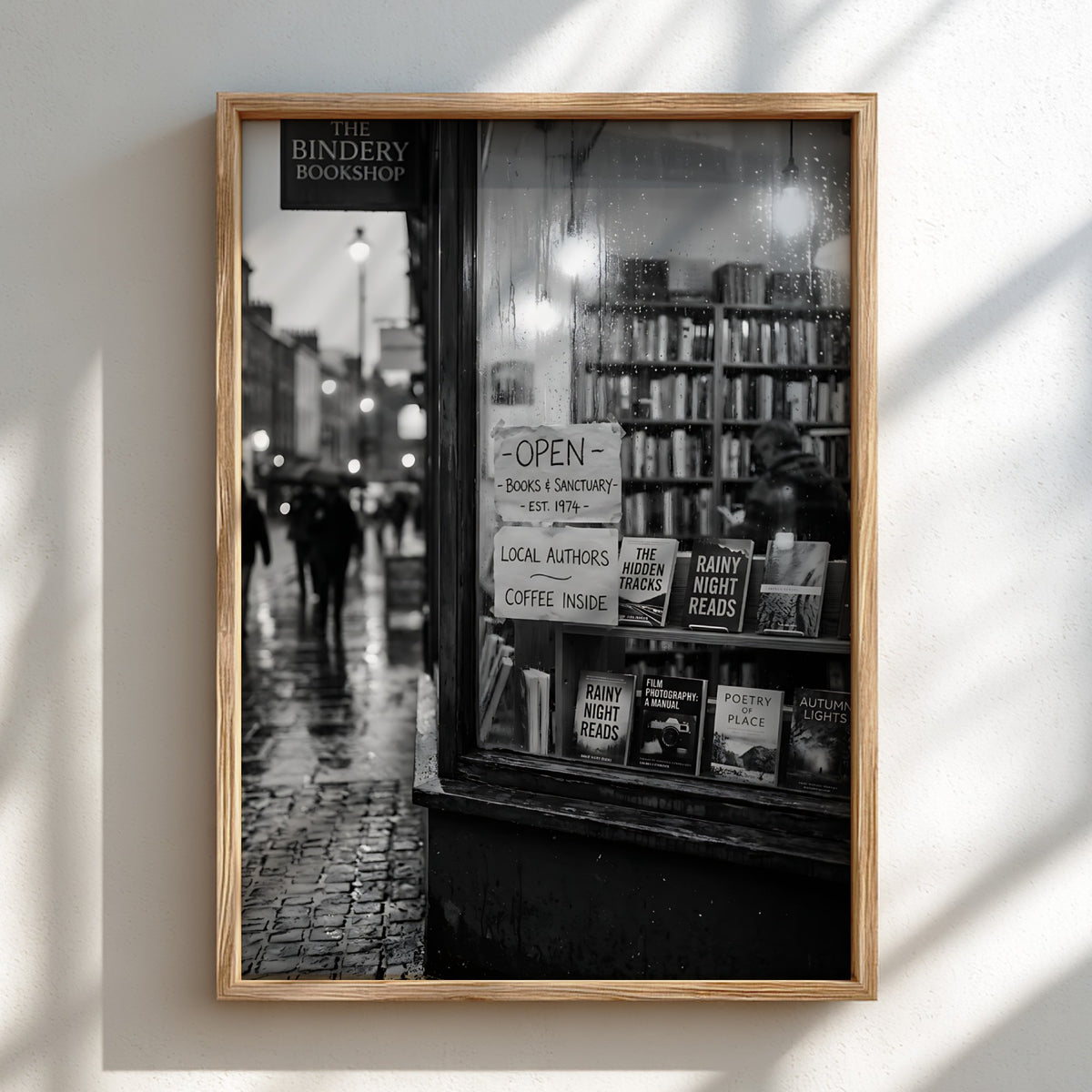 Black and white photographic wall decor showing a rainy evening bookshop window with books and reflections