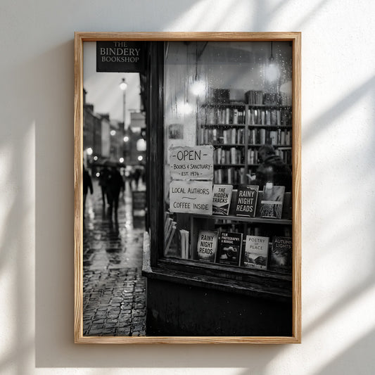 Black and white photographic wall decor showing a rainy evening bookshop window with books and reflections