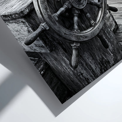 Black and white wall decor showing brass ship wheel on wooden deck with nautical ropes