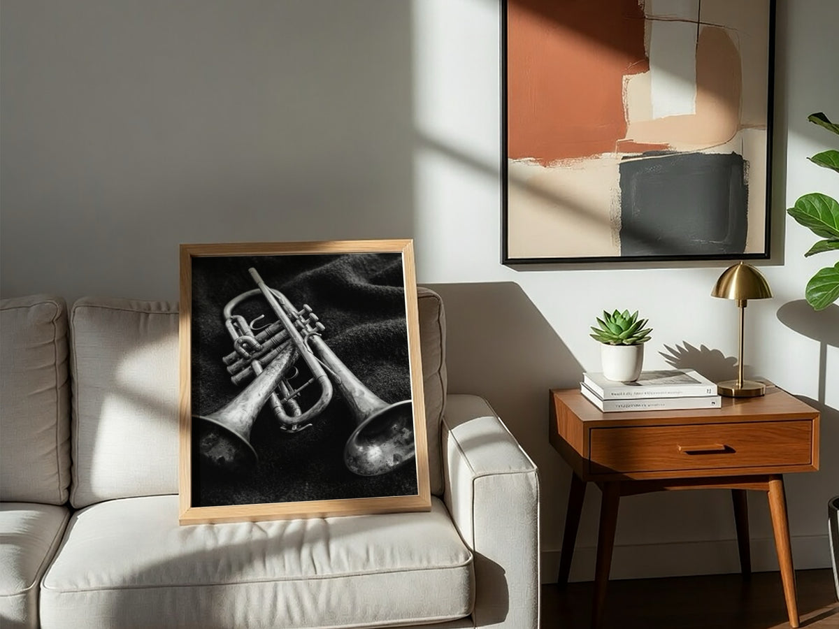 Photography print of two brass trumpets on dark fabric in black and white