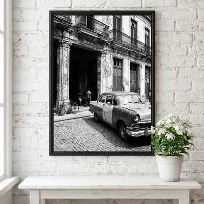 Black and white poster of vintage car parked on Havana street with colonial building and cobblestones