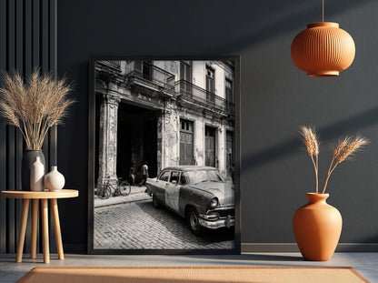 Black and white poster of vintage car parked on Havana street with colonial building and cobblestones