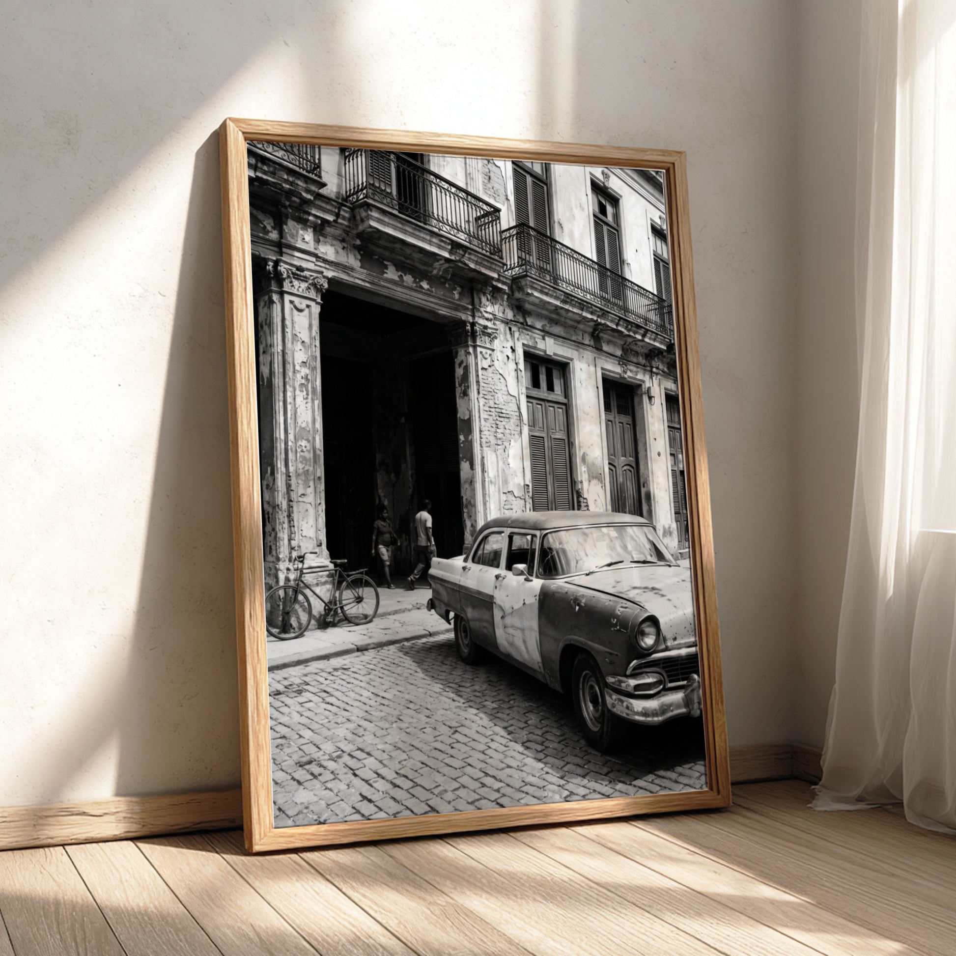 Black and white poster of vintage car parked on Havana street with colonial building and cobblestones
