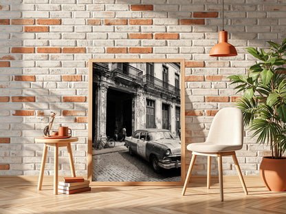 Black and white poster of vintage car parked on Havana street with colonial building and cobblestones