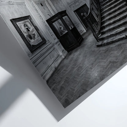Black and white cinema lobby poster with sweeping staircase and chandelier in vintage style