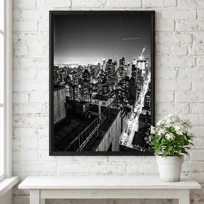 City skyline at night poster in black and white with glowing lights and tall buildings
