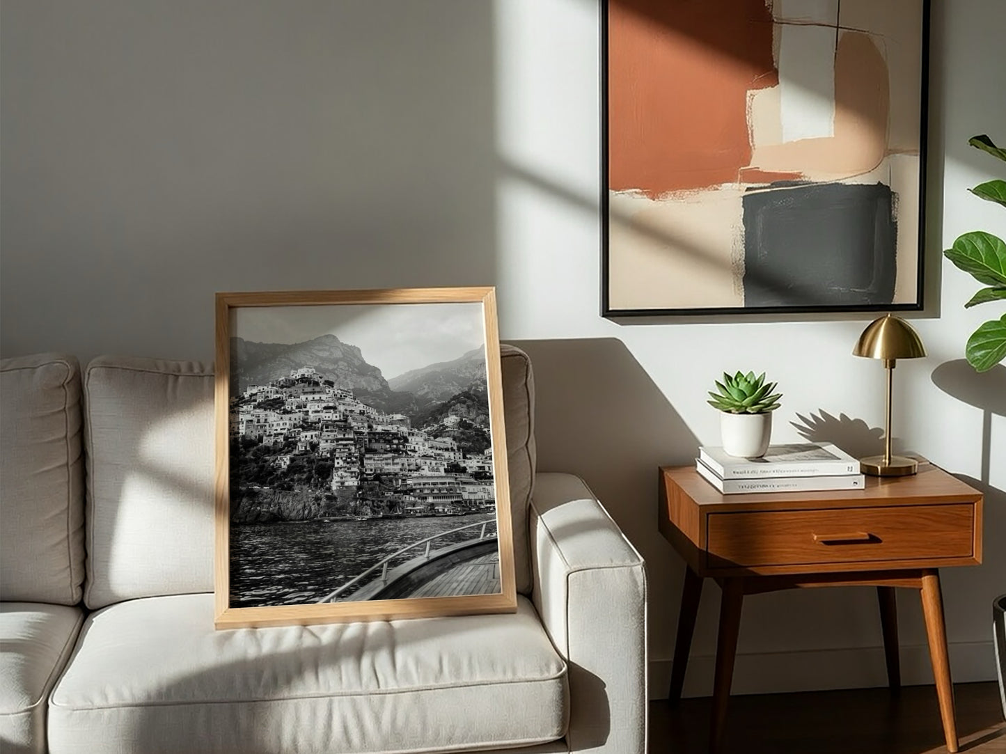 Black and white poster of cliffside village viewed from boat with coastal houses and mountain background