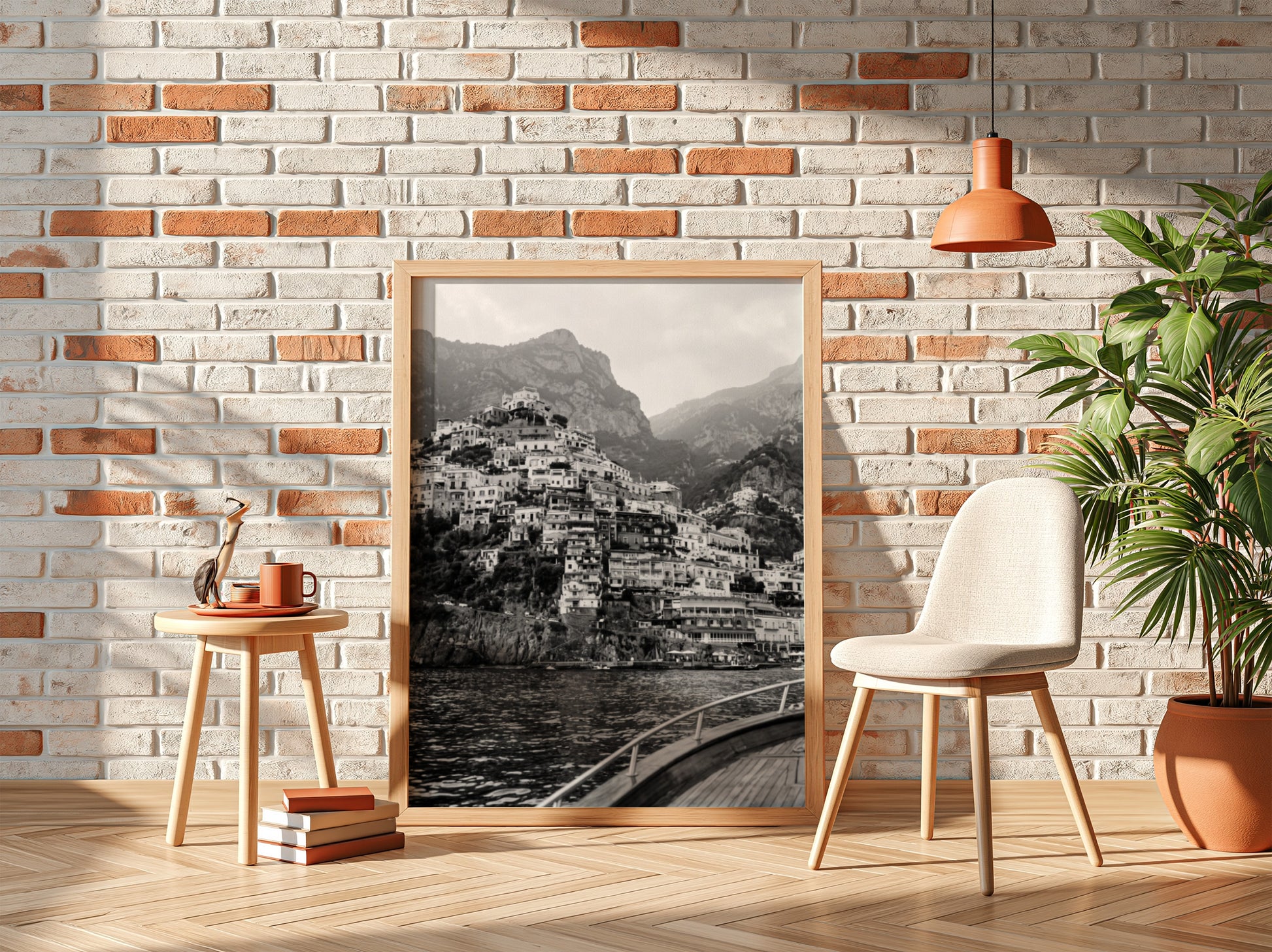 Black and white poster of cliffside village viewed from boat with coastal houses and mountain background