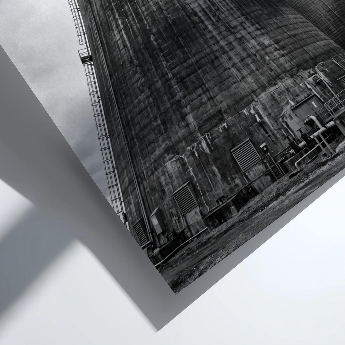 Black and white poster of industrial cooling towers with steam against cloudy sky