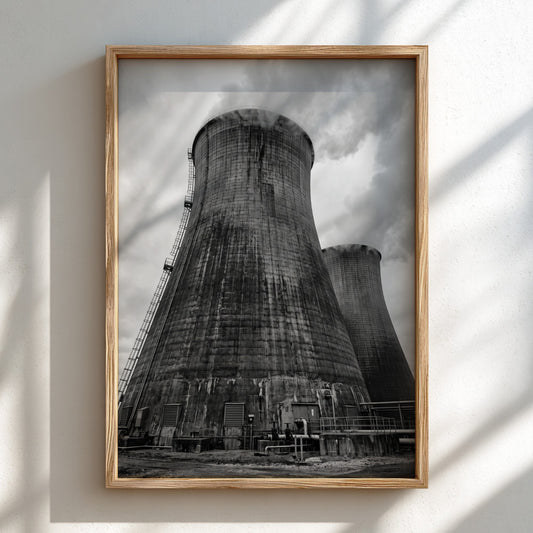 Black and white poster of industrial cooling towers with steam against cloudy sky