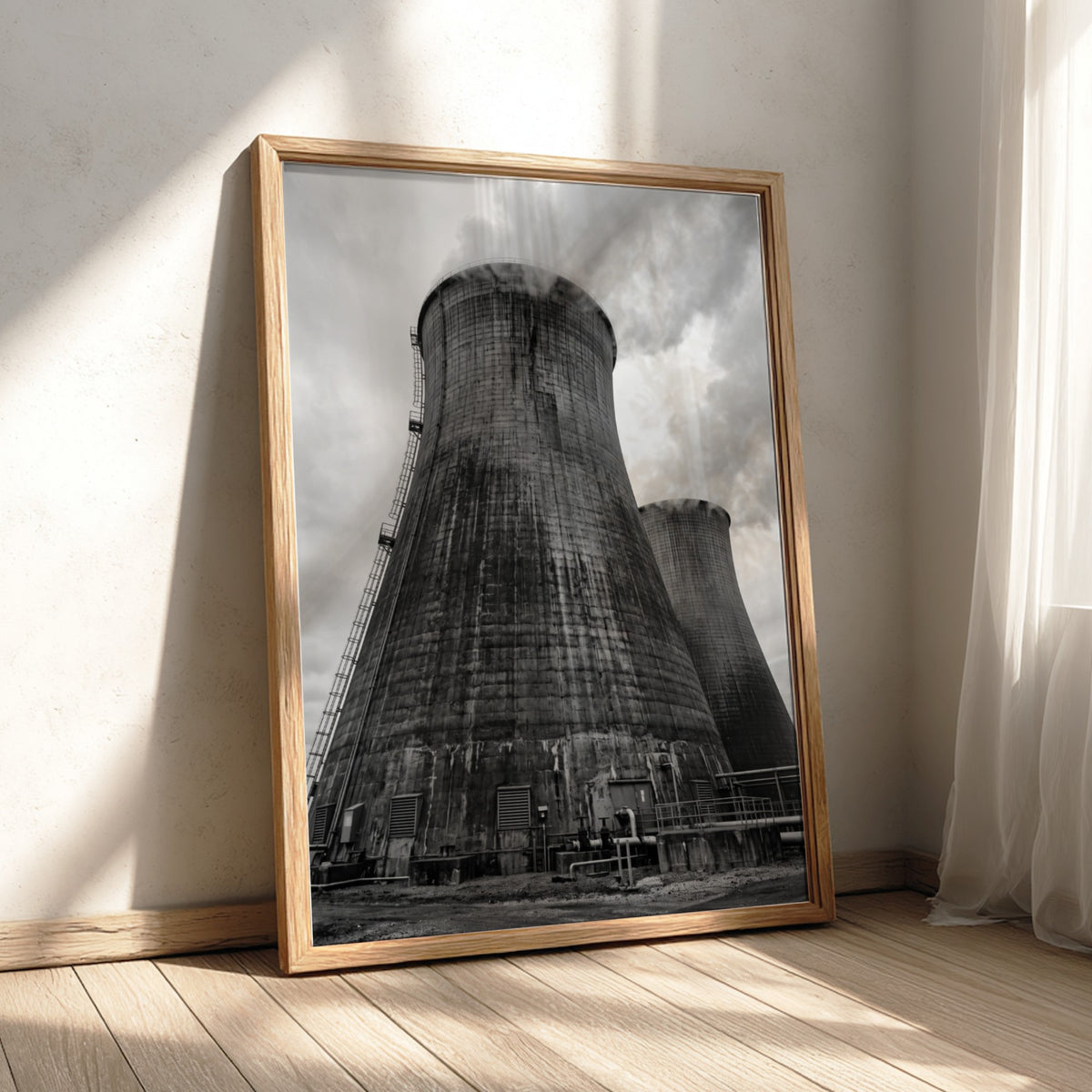 Black and white poster of industrial cooling towers with steam against cloudy sky
