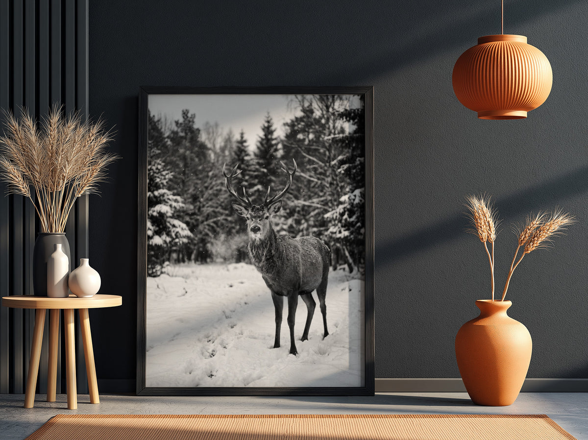 black and white nature wall decor showing deer standing in snowy forest clearing with pine trees