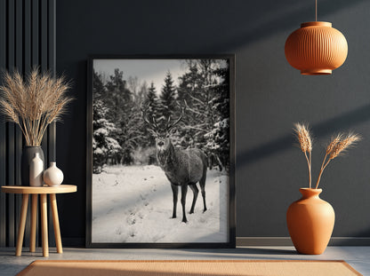black and white nature wall decor showing deer standing in snowy forest clearing with pine trees