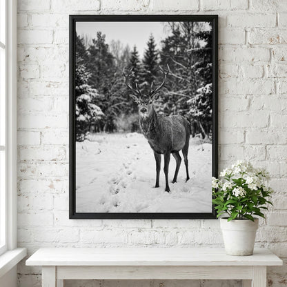 black and white nature wall decor showing deer standing in snowy forest clearing with pine trees