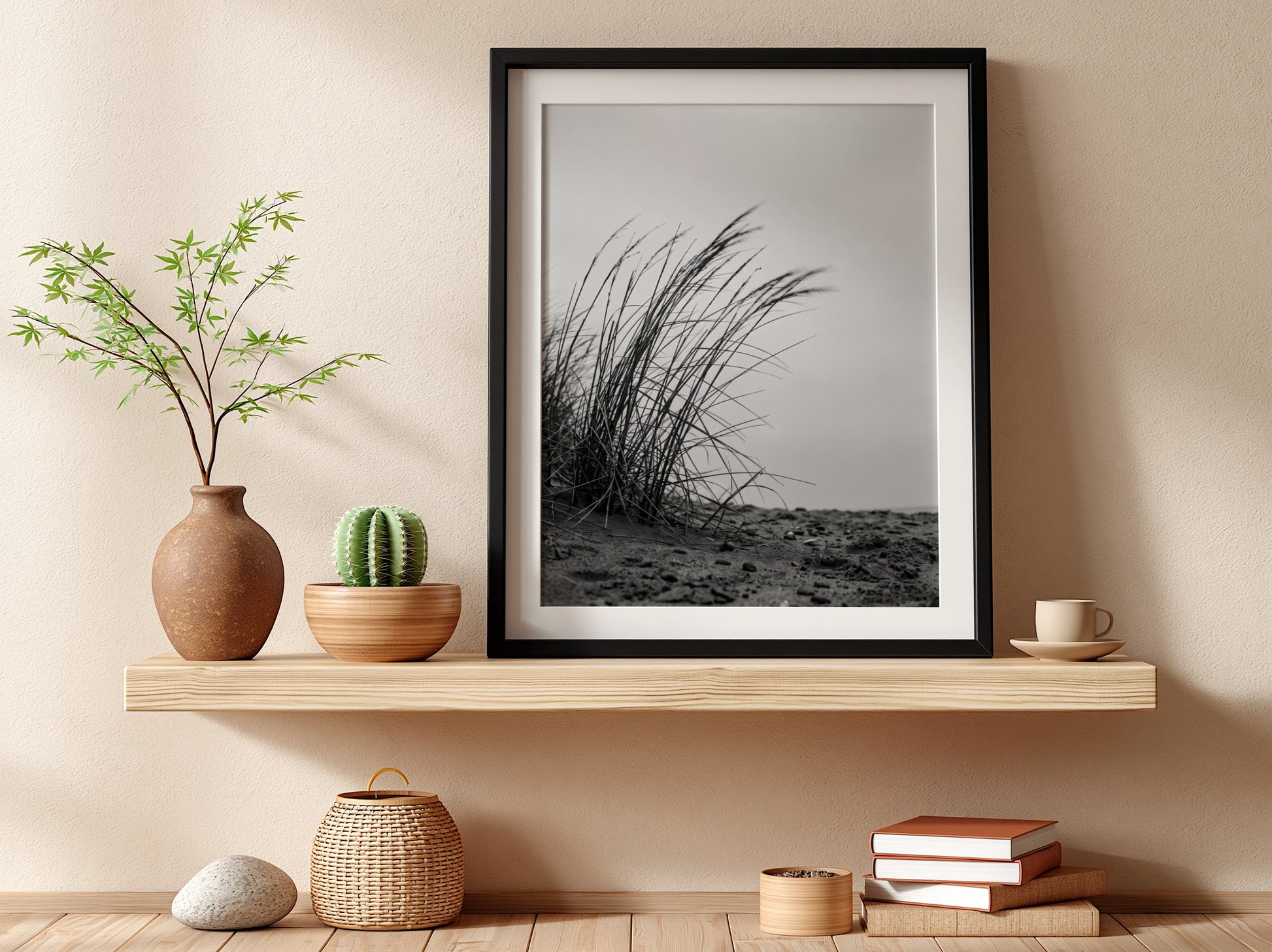 Black and white poster showing dune grass bending in wind on sandy ground with soft shadows