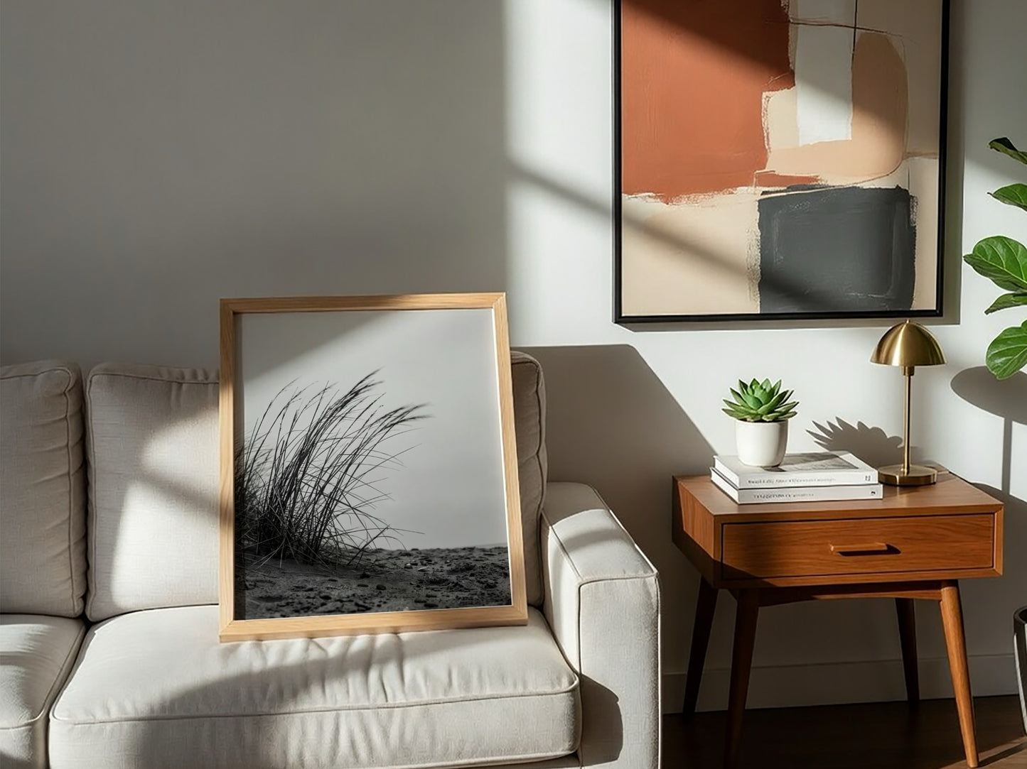 Black and white poster showing dune grass bending in wind on sandy ground with soft shadows