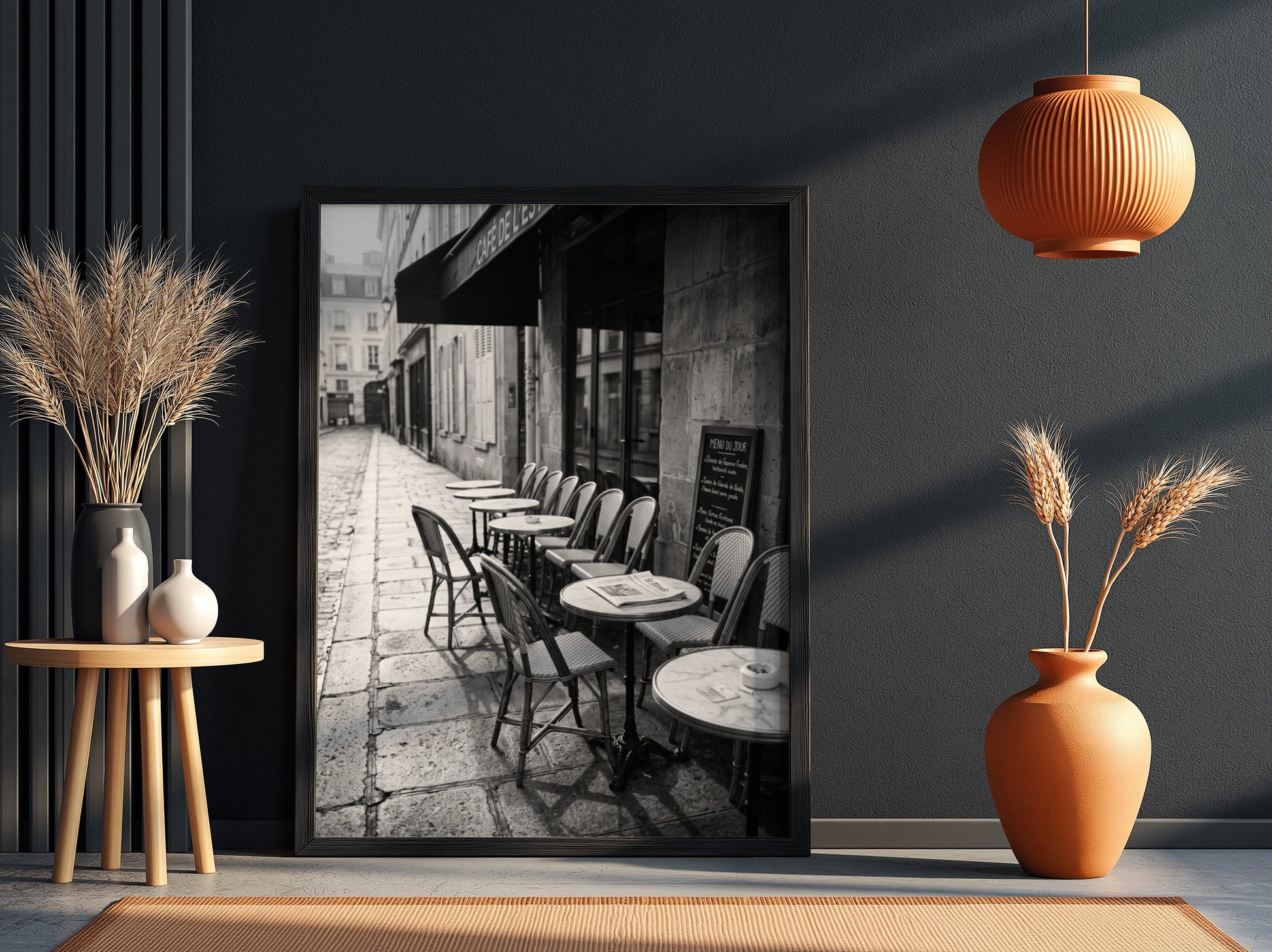 Black and white wall decor featuring empty Parisian cafe terrace with chairs and tables on cobblestone street