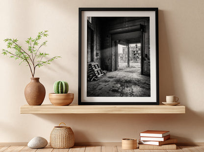 Poster of empty factory loading dock with black and white industrial interior and scattered pallets