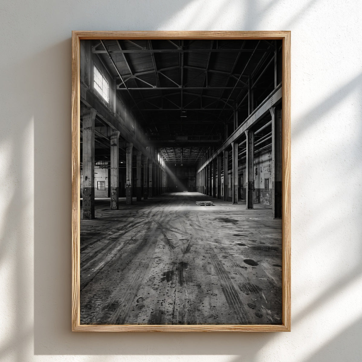 Poster of empty warehouse interior with monochrome tones and natural light beams