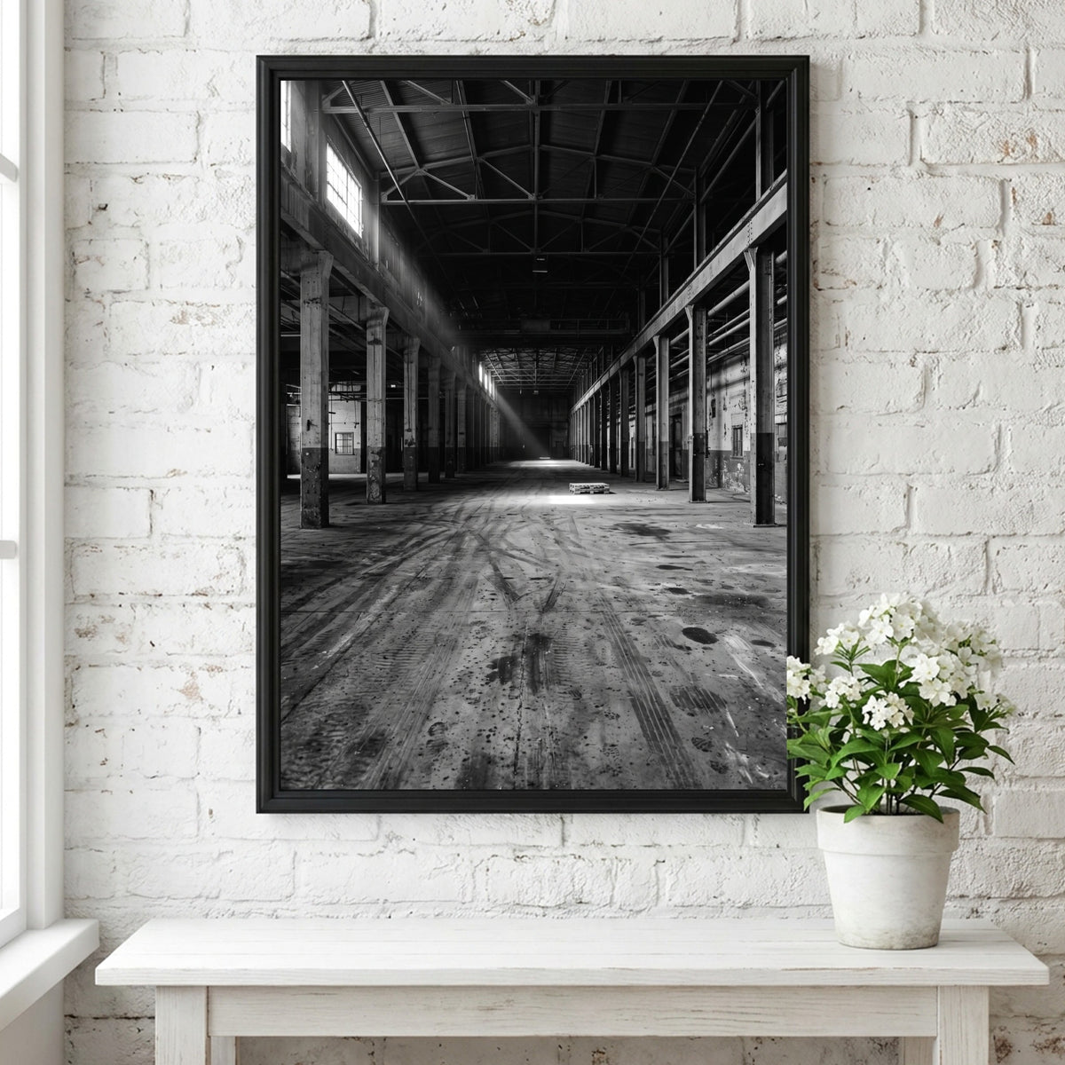 Poster of empty warehouse interior with monochrome tones and natural light beams