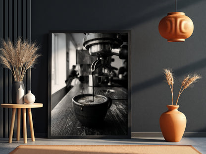 Black and white poster showing espresso pouring from coffee machine into cup on wooden surface