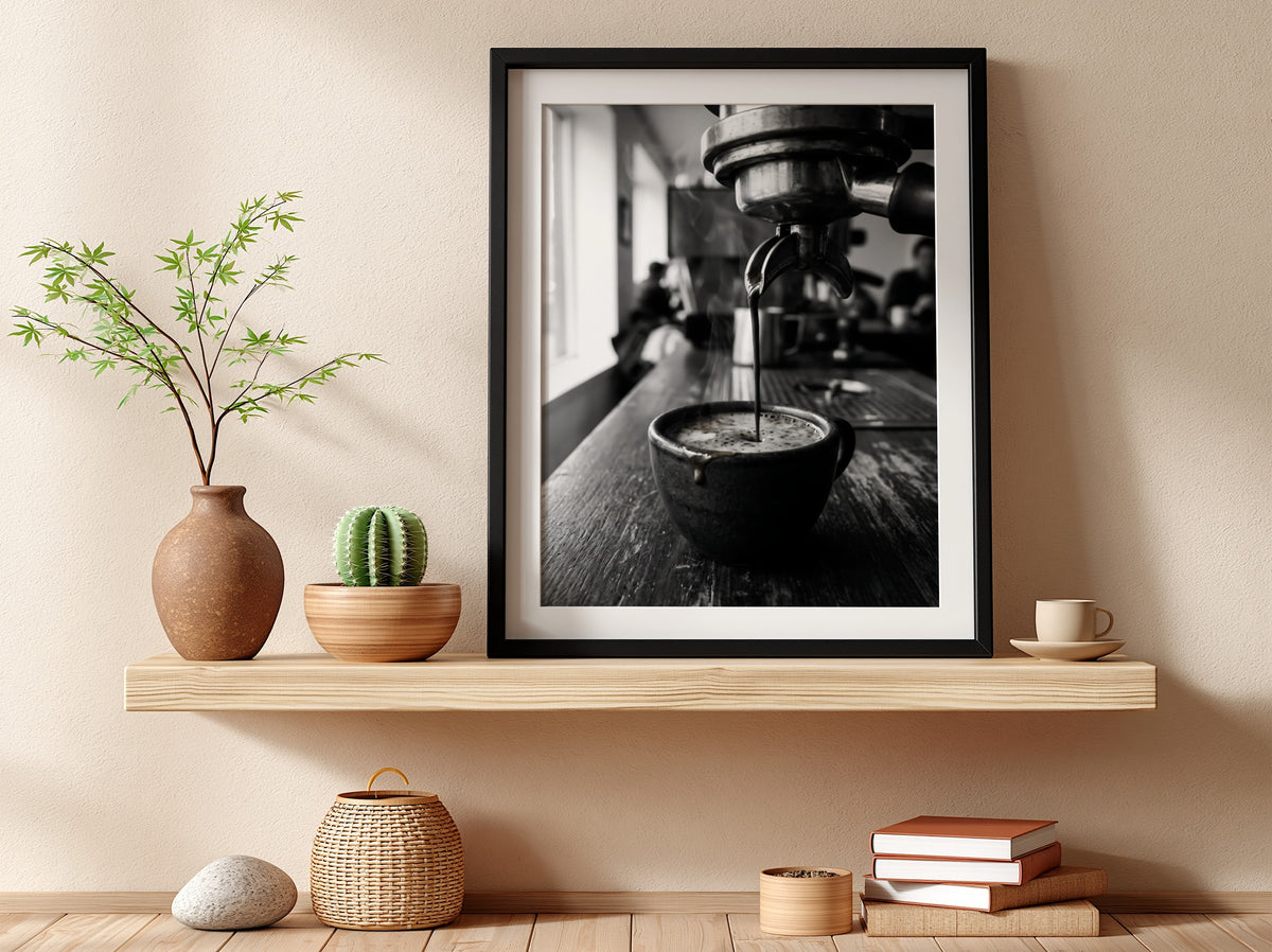Black and white poster showing espresso pouring from coffee machine into cup on wooden surface
