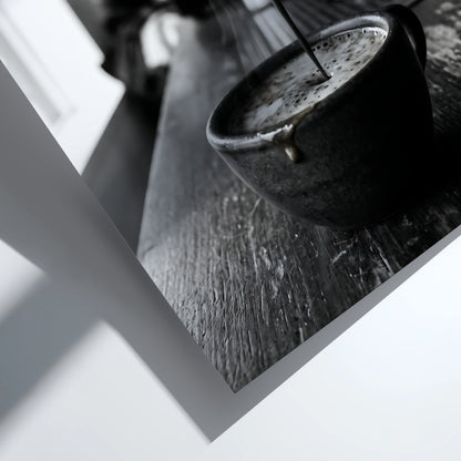 Black and white poster showing espresso pouring from coffee machine into cup on wooden surface