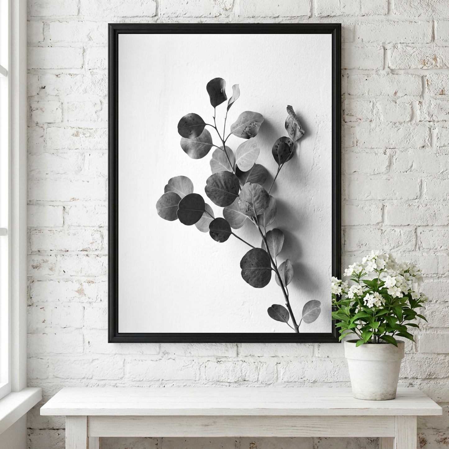 botanical wall decor featuring grayscale eucalyptus branch with rounded leaves on white background