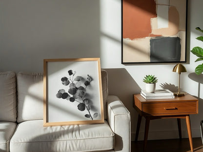 botanical wall decor featuring grayscale eucalyptus branch with rounded leaves on white background
