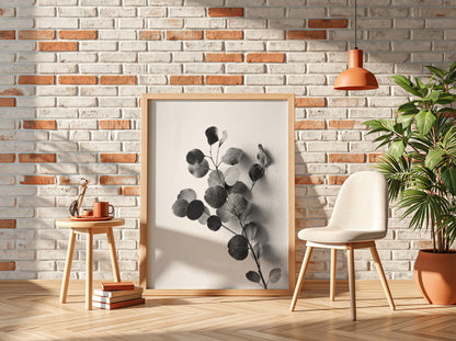 botanical wall decor featuring grayscale eucalyptus branch with rounded leaves on white background