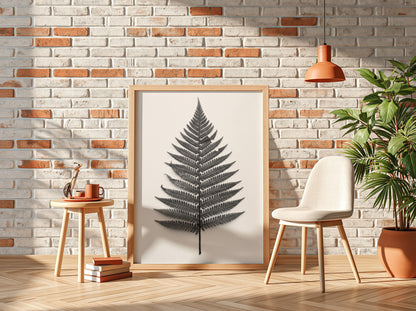 Botanical poster showing a detailed monochrome fern frond laid flat with natural wood frame and soft shadows