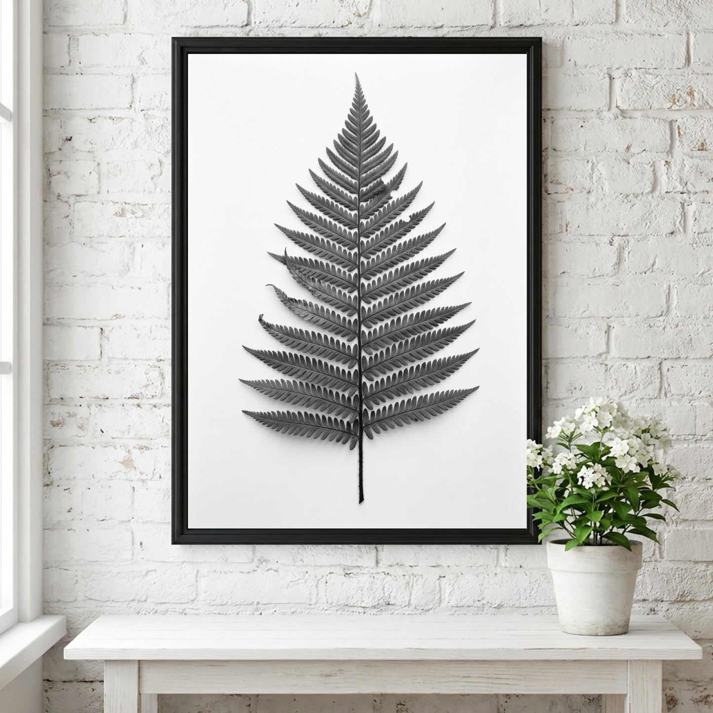 Botanical poster showing a detailed monochrome fern frond laid flat with natural wood frame and soft shadows